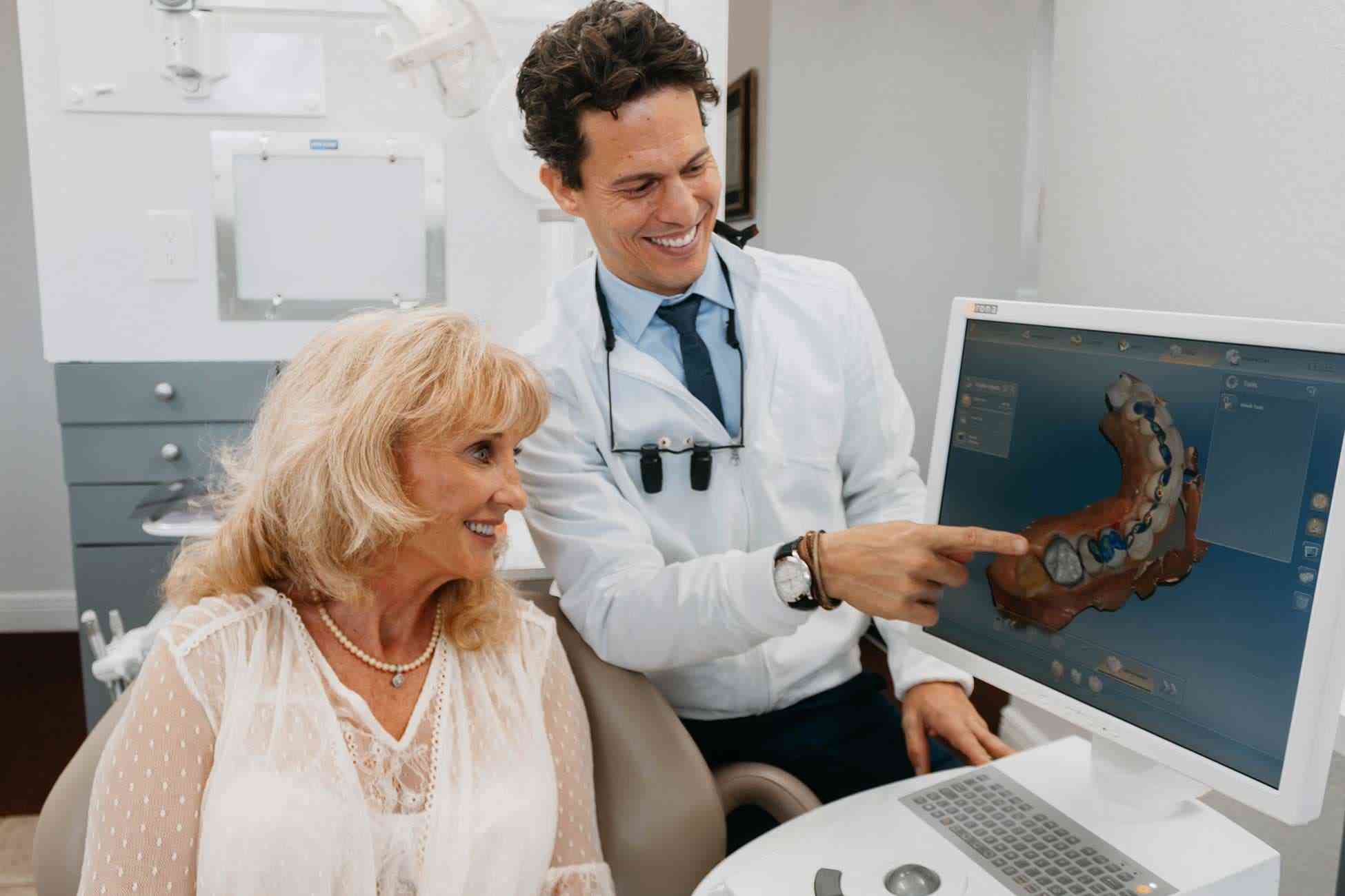 Dr. Macedo showing a patient her 3D digital smile design